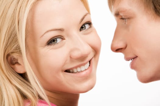 Charming woman looking at camera with her boyfriend at background