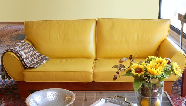 Yellow leather sofa couch interior sunflower bouquet