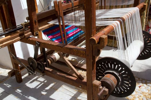antique vintage spinner machine working in mediterranean fabric