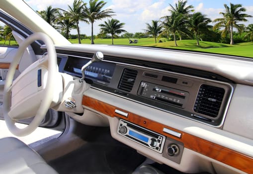 retro vintage car indoor with Caribbean golf course in window view
