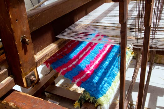 antique spinner machine working in mediterranean fabric