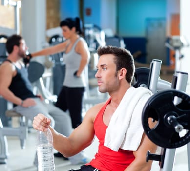 man relaxed on gym after fitness sport training with water bottle