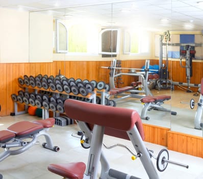 Gym interior body buliding weights exercise room wooden wall