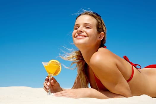Portrait of young woman with closed eyes holding orange juice