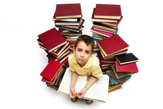 Photo of tired boy with book looking at camera
