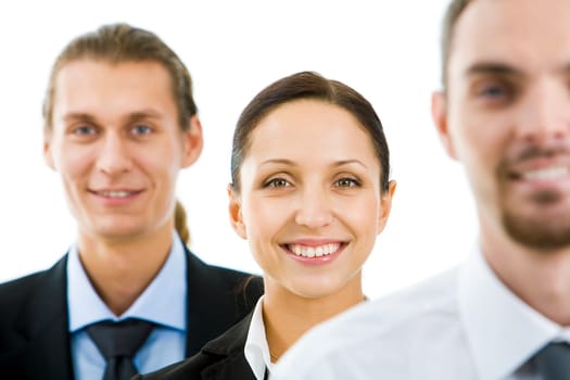 Portrait of happy businesswoman smiling at camera with colleagues