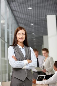 A beautiful businesswoman looking at camera in working environment
