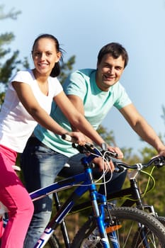 Portrait of two young people on bikes