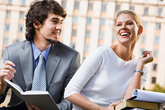 Happy students are studing lectures near university