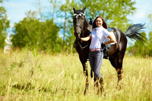 Image of happy female with purebred horse outdoors