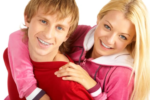 Portrait of happy guy being hugged by his pretty girlfriend