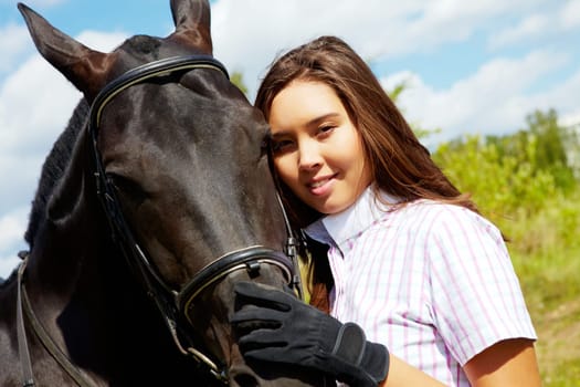 Image of happy female with purebred horse near by