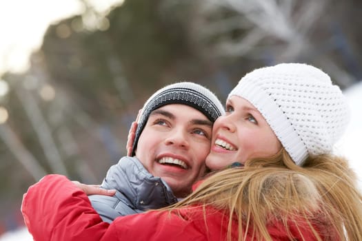 Portrait of happy couple looking upwards while embracing