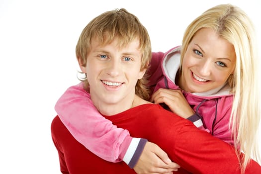 Portrait of happy guy being hugged by his pretty girlfriend