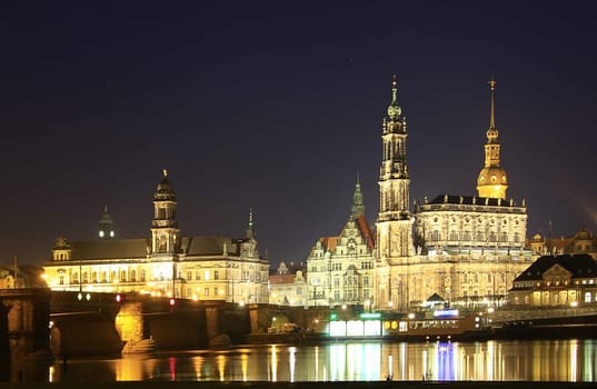 View from the Augustus Bridge to the old town silhouette of Dresden with the Hofkirche at dusk