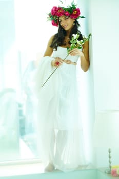 Beautiful woman in floral wrath looking aside
