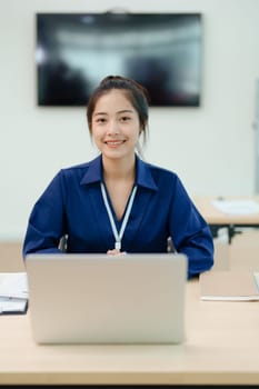 Young asian businesswoman manager, lawyer or company employee holding accounting bookkeeping documents checking financial data or marketing report working in office with laptop. Paperwork management.