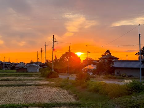 Sunset glow on quiet neighborhood and harvested fields in rural Japan. High quality photo