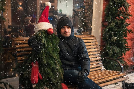 Man with fir tree decorated mannequin. Xmas holidays, New Year or Christmas concept