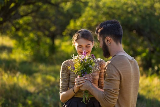 guy gives his girlfriend wild flowers