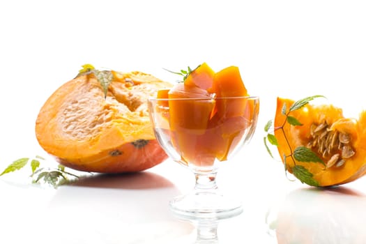 Prepared sweet pumpkin marmalade in a glass bowl isolated on a white background. Autumn recipes.