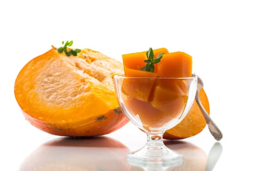 Prepared sweet pumpkin marmalade in a glass bowl isolated on white background. Autumn recipes.