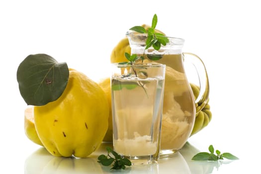Prepared compote from ripe natural autumn quince, in a glass glass and decanter isolated on a white background.