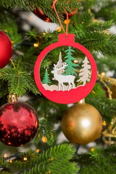Big christmas tree decorated with beautiful red baubles at home. Copy space.