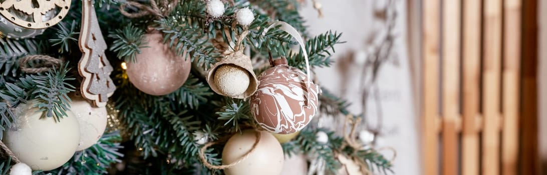 Diy honeycomb paper christmas ornaments hanging from Christmas tree by a window