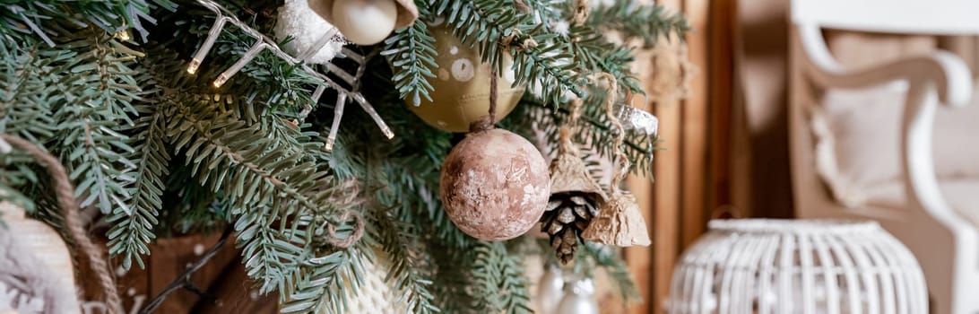 Diy wooden, paper christmas ornaments hanging from Christmas tree.Festive winter holidays background