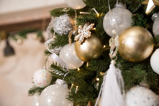 Photo of luxury gift boxes under Christmas tree, New Year home decorations, golden wrapping of Santa presents
