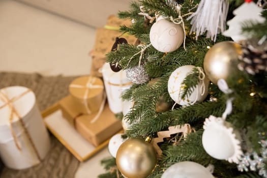 Magic glowing tree. Christmas home interior with Christmas tree. Red and white balls hanging on pine branches.