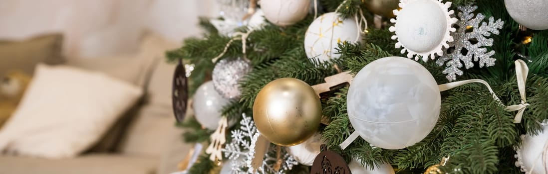 Magic glowing tree. Christmas home interior with Christmas tree. Red and white balls hanging on pine branches.