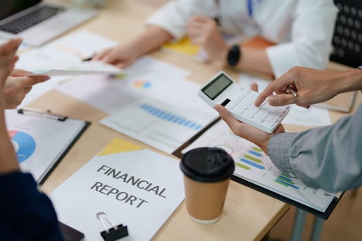 Two business people meeting to talking or discuss marketing work in workplace using paperwork, calculator, computer to work.