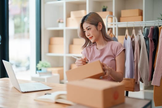 Asian female business owner handles delivery of orders to customers.