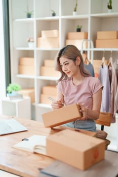 Asian female business owner handles delivery of orders to customers.