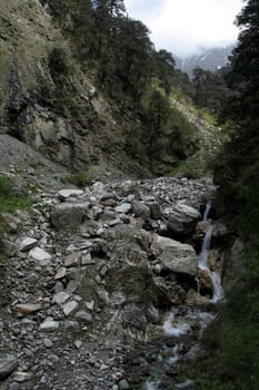 Thin flow of water in stony bed of river Yamuna near Yamunothri, Uttarakhand, India, Asia