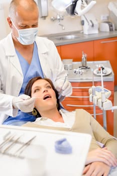 Woman patient at dental surgery with male hygienist stomatology clinic