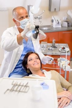 Woman at dental clinic surgery with male stomatology hygienist