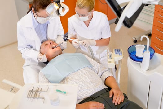 Male patient having dental checkup at surgery stomatology clinic