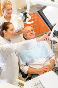 Portrait of mature man consultation with dentist surgeon stomatology clinic