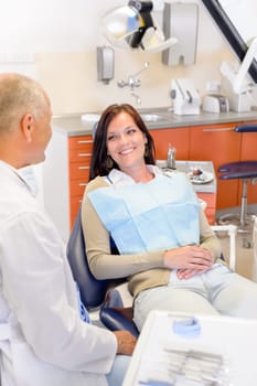 Woman at dental clinic surgery with male stomatology hygienist