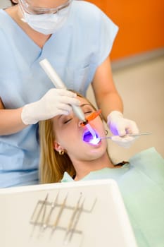 Young woman having dental surgery in stomatology clinic teeth checkup