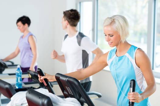 Walking on treadmill young people running exercise at fitness center
