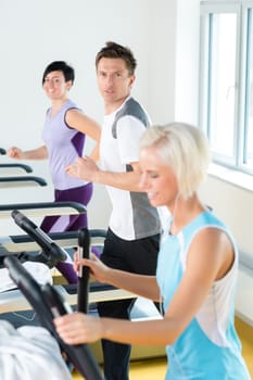 Walking on treadmill young people running exercise at fitness center