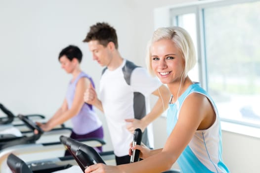 Walking on treadmill young people running exercise at fitness center