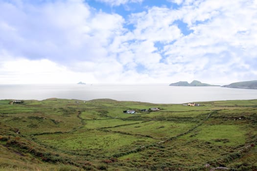 scenic view in kerry ireland of fields coastline and skellig rock