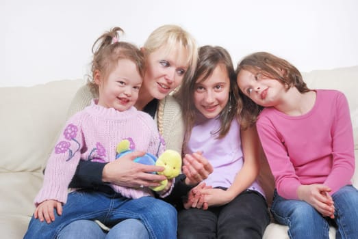 Family sitting in living room on sofa