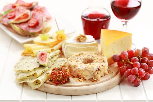 Catering cheese platter with red wine