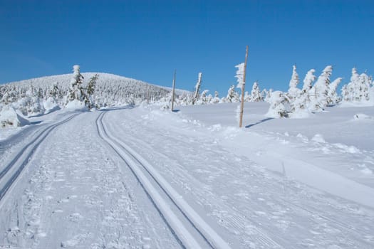 Winter mountain landscape scenery with cross country skiing way. Horizontally. (Mountains Jeseniky, Czech Republic)